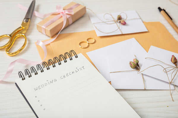 Wedding Checklist Surrounded by Scissors, Invites and Rings