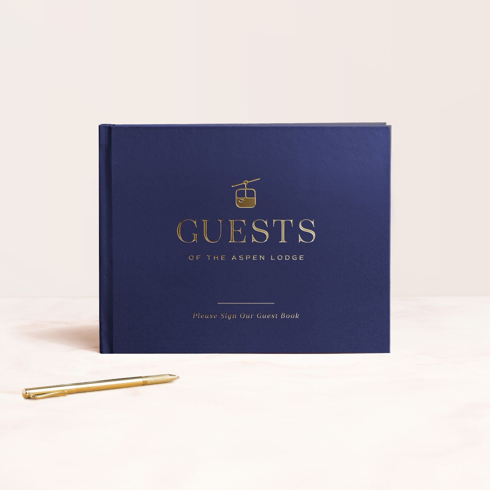 a blue book with a gold pen next to it